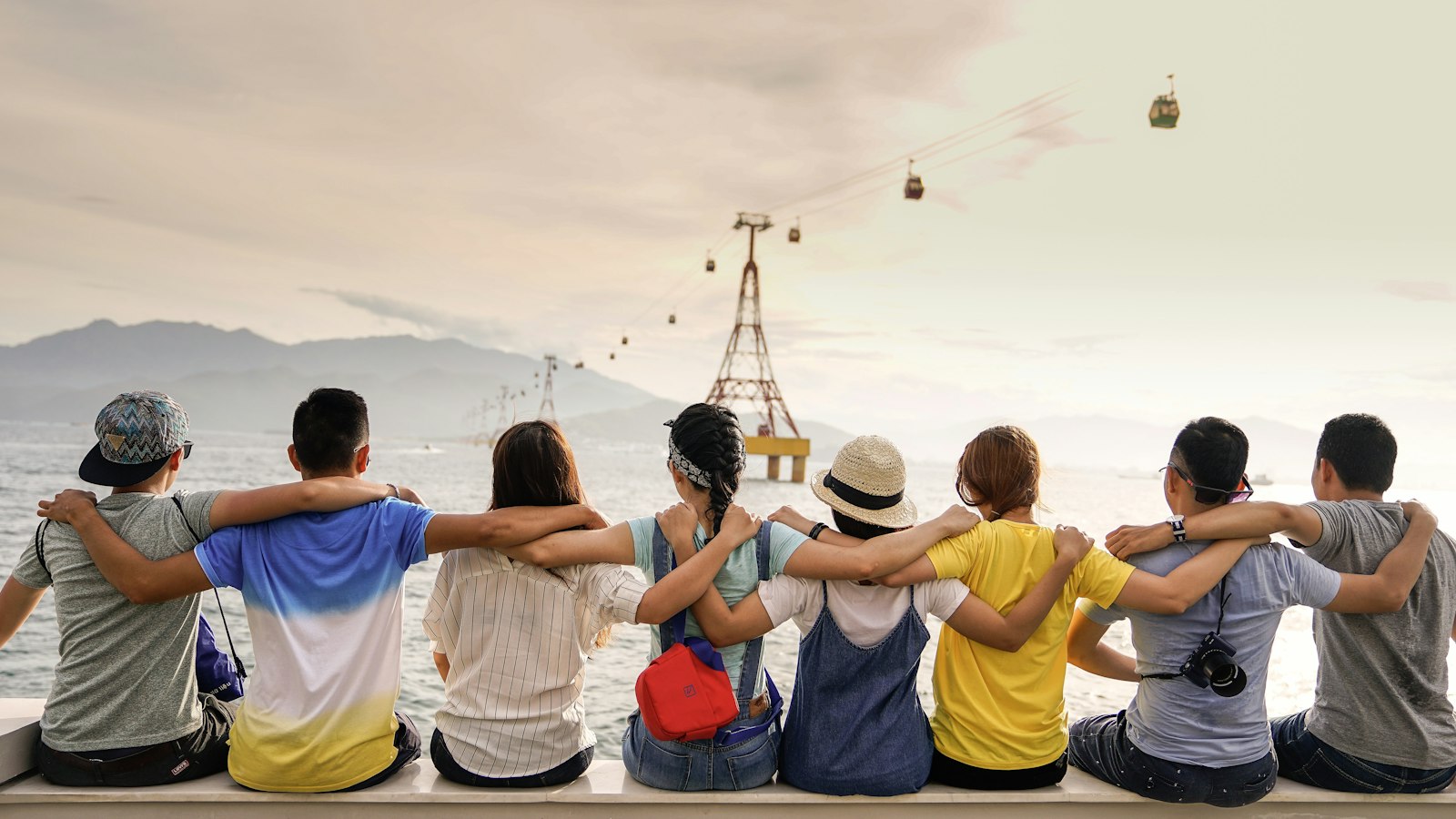 A group of young adults sitting together outdoors